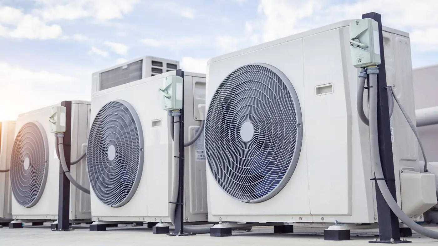 Row of commercial air conditioning outdoor units on a rooftop in Bristol