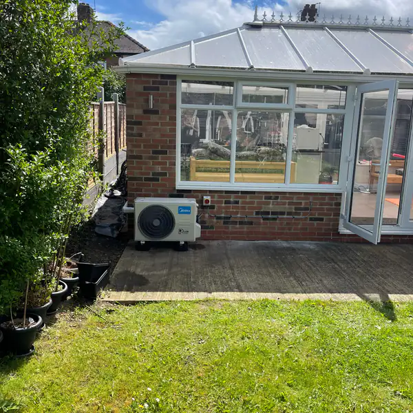 Air conditioning outdoor unit beside a garden conservatory in Bristol