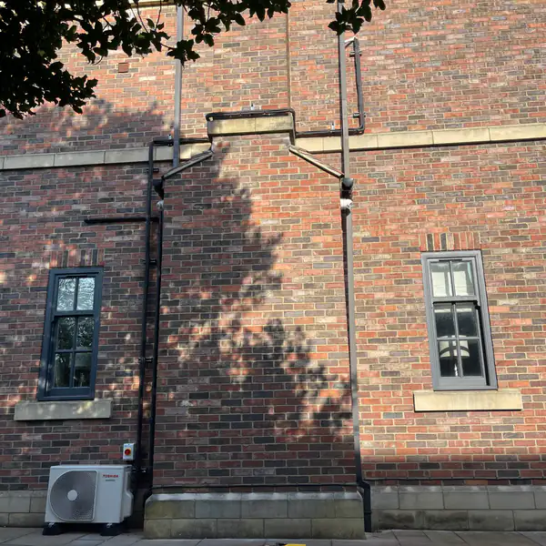 Toshiba air conditioning outdoor unit with neat trunking on a period building in Bristol